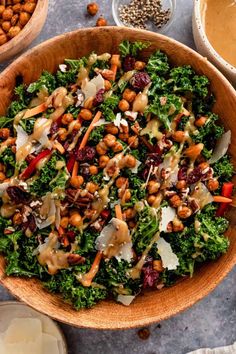 a salad in a wooden bowl surrounded by other ingredients