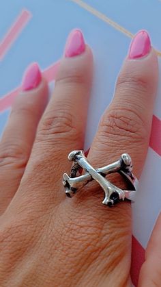 Product Description: This handmade Bones Ring-Skull ring is a unique and stylish piece of jewelry made from high-quality 925 silver. It features an anatomically accurate design with immaculate detail, showcasing the wearer's love for Bones and gothic style. At 10 grams, it's a substantial piece that stands out from the crowd, suitable for biker enthusiasts and fans of punk music. It's a perfect gift for yourself or for a loved one who appreciates unique and artisanal pieces. Highlights: - Handma Gothic Metal Skull Ring Gift, Hand-cast Skull Ring For Gift, Adjustable Metal Punk Skull Ring, Unique Hand-cast Skull Ring, Gothic Hand-cast Skull Jewelry, Biker Look, Bone Ring, Silver Skull Ring, Stylish Rings