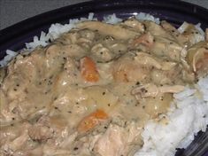 a purple plate topped with rice and meat covered in gravy