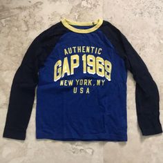 Nwot Boys Gap Long Sleeve Logo T-Shirt. Navy Colored Sleeves, Bright Blue Body With Yellow Lettering And Collar. Boys Size M (8-9). Tags Removed And Washed But Excellent Never Worn Condition From Smoke Free And Pet Free Home. Gap Cotton Tops With Logo Print, Gap Crew Neck Top With Letter Print, Gap Long Sleeve Top With Letter Print, Blue Cotton T-shirt By Gap, Blue Long Sleeve Shirt With Letter Print, Navy Long Sleeve Tops With Logo Print, Blue Letter Print Shirt For Fall, Gap Blue Graphic Print Top, Blue Shirt With Letter Print For Fall