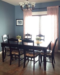 a dining room table with chairs and a chandelier