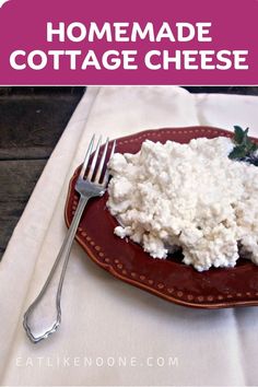 a plate with cottage cheese on it next to a fork