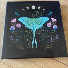 a painting of a blue butterfly on a black background with flowers and butterflies around it