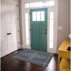 a blue front door and yellow side table in a white room with wood floors, green door