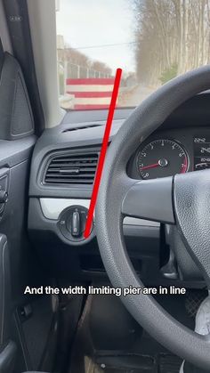 the inside of a car with an arrow pointing to the dash light and steering wheel