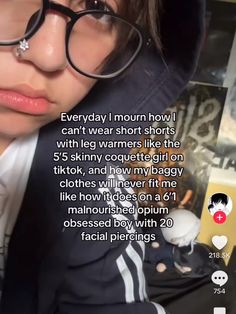 a woman wearing glasses and a jacket with an instagram on the screen above her head