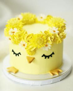 a yellow cake decorated with flowers and birds