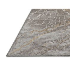 an area rug with grey and gold marble pattern on the top, in front of a white background