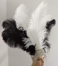 "We make and ship our items really fast if you need it for a specific date please let us know. or call/text us at 954-3051817 to complete your order over the phone Prime wing Ostrich Plumes Feathers Carnival Headdress Showgirl on a Crystal Rhinestone tiara/crown Headdress approximate height including crown is approx 22\" Prime quality Ostrich feathers in white and black Secured with a glitter elastic band A miamifeathers original All the items are new! Please Note regarding shipping: Even though Costume Party Hats With Ostrich Feathers, Costume Party Hat With Ostrich Feather Trim, White Costume Hats And Headpieces For Carnival, Ostrich Feather Trim Hat For Costume Party, Fitted Feather Costume Hat, Carnival Costume Hat With Feather Trim, White Feathered Hat Headpiece, Black Ostrich Feather Trim Headpiece, White Ostrich Feather Headpiece With Feather Trim