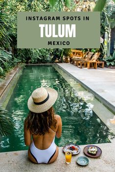 a woman sitting on the edge of a pool with her back to the camera