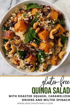 quinoa salad with roasted squash, caramelized onions and spinach in a white bowl