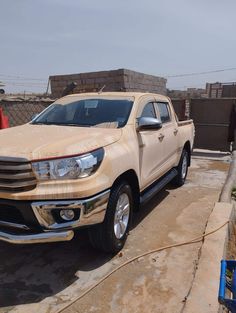 a white truck parked in front of a building next to a man standing on the sidewalk