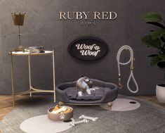 a dog bed sitting on top of a rug in front of a sign that says ruby red