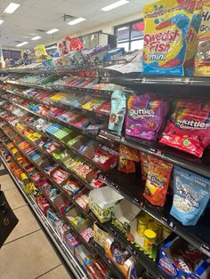 a grocery store filled with lots of different types of food and snacks on display in the aisle