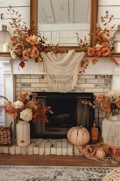 a fireplace decorated for fall with pumpkins, flowers and other autumn decorating items