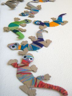 colorful paper cut out lizards on white surface