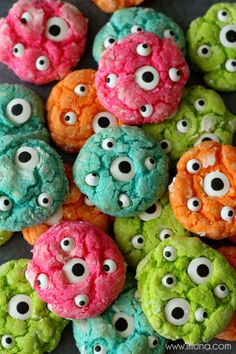 colorful cookies with gooey monster eye eyes on them are ready to be eaten for halloween