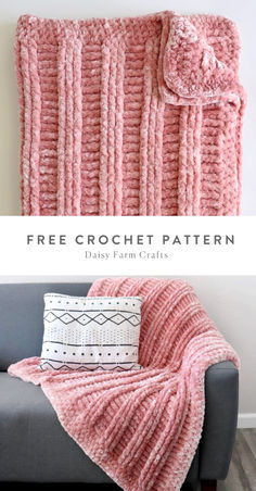 a pink crochet blanket sitting on top of a couch next to a pillow