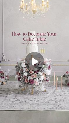 a cake table with flowers and candles on it, in front of a chandelier that says how to decorate your cake table