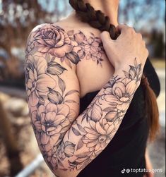 a woman with flowers on her arm and shoulder