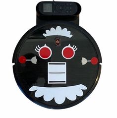 a black and white clock with red eyes