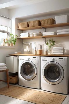 a washer and dryer sitting in a room next to each other with towels on the shelves