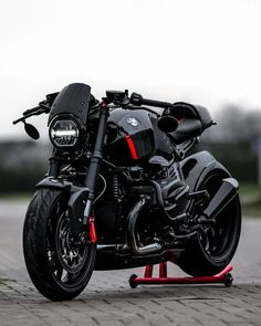 a black motorcycle parked on top of a parking lot