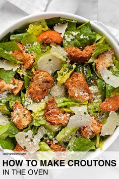 a white bowl filled with lettuce and meat on top of a marble table