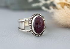 Handcrafted Purple Spiny Oyster Silver Statement Cocktail Ring. The setting is an oval cabochon 14mm x 10mm that is in a Bezel setting. The 925 Sterling Silver has been fused, stamped and lightly oxidized. The band is a tapered wide band 1/4" to 1/8" and cannot be resized. Size 9 This handmade artisan piece with its coastal cowgirl vibe, makes a bold statement wherever you wear it. The eye catching purple hue of the Spiny Oyster shell adds a pop of color to any outfit, while the chunky, creative Artisan Oval Cabochon Ring, Sterling Silver Amethyst Ring With Cabochon, Silver Amethyst Cabochon Rings, Adjustable Purple Cabochon Ring, Silver Amethyst Cabochon Ring In Sterling Silver, Purple Spiny Oyster Jewelry, Vero Beach Fl, Coastal Cowgirl, Trendy Boho