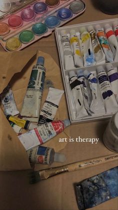 an assortment of art supplies sitting on top of a table