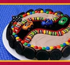 a birthday cake with cars on it is decorated like a race track and the words race car cheesecake