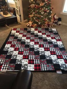 a christmas tree is next to a black and white quilt