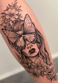 a woman's face with butterflies and flowers on her leg