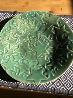 a green plate sitting on top of a table