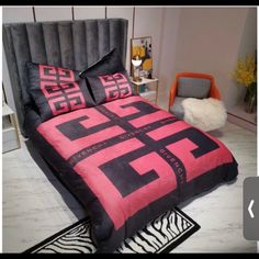 a bed with pink and black comforters in a room next to a zebra rug