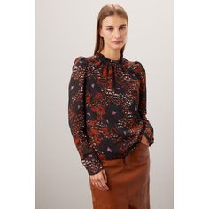 Brown floral chiffon (100% Recycled Polyester). Top. Long sleeves. Mock neck. Pull on. Imported. Ruffled Puff Sleeve Top For Work In Fall, Puff Sleeve Top With Ruffles For Work In Fall, Fall Ruffled Puff Sleeve Top For Workwear, Fall Floral Print Long Sleeve Puff Sleeve Top, Chic Long Sleeve Puff Top With Floral Print, Chic Tops With Floral Print And Bishop Sleeves, Chic Floral Print Puff Sleeve Top For Fall, Chic Floral Puff Sleeve Top For Fall, Chic Puff Sleeve Top With Floral Print For Fall