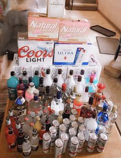 several bottles of alcohol are stacked on a table