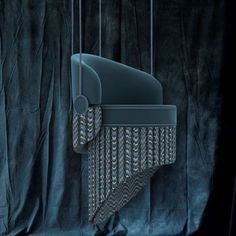 an artistic image of a chair hanging from a string in front of a black background