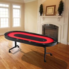 a ping pong table sitting on top of a hard wood floor next to a fireplace