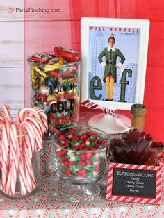 candy and candies are displayed on a table with a framed poster in the background