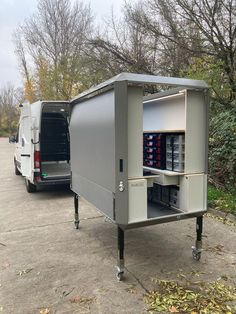 a van is parked next to an outdoor storage unit