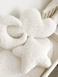 two white teddy bears laying on top of a crib