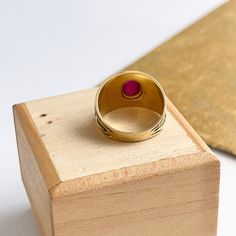 Estate/ vintage 14KT yellow Gold Byzantine/ Etruscan design polished + textured matte finish cigar band ring with genuine ruby. Elegant, old world piece with faceted, oval-shaped, cabochon, genuine red ruby. Ruby measures: 8mm x 5.7mm Size 7 Can be sized by your local jeweler or ours for a fee Solid Measures: 13.6mm wide~ graduated back to 3.5mm Weight: 4.6 grams Excellent condition Formal Ruby Signet Ring, Ruby Signet Ring With Bezel Setting For Formal Occasions, Formal Ruby Signet Ring With Bezel Setting, Heirloom Ruby Signet Ring With Hallmark, Yellow Gold Ruby Signet Ring As Gift, Classic Ruby Signet Ring As A Gift, Vintage Ruby Signet Ring As Gift, Heirloom Ruby Signet Ring With Polished Finish, Antique Hallmarked Ruby Signet Ring