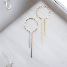 Modern Open Hoop Keyhole Earrings - Made with 14k Gold filled, these are shaped and handmade from 20 gauge wire.* Approximately 2" in length and .75 inches diameter at the hoop.* Polished to a high shine * Handmade in Montana* Sent in a ribboned gift box with a polishing cloth Minimalist Gold Hoop Threader Earrings, Gold Hoop Threader Earrings For Gift, Modern Hoop Threader Earrings As Gift, Modern Wire Wrapped Hoop Earrings For Gift, Modern 14k Gold Filled Pierced Hoop Earrings, Modern 14k Gold-filled Pierced Hoop Earrings, Modern Wire Wrapped Dangle Hoop Earrings, Minimalist Wire Wrapped Yellow Gold Hoop Earrings, Minimalist Yellow Gold Wire Wrapped Hoop Earrings