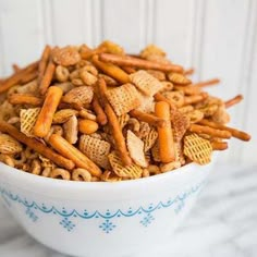 a bowl filled with cheetos sitting on top of a table