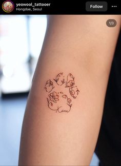 a person with a tattoo on their arm that has cats and dogs in the center