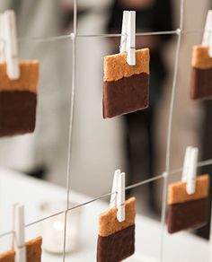 two pictures of people brushing their teeth in front of some cookies hanging on a line