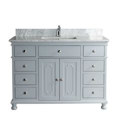 a bathroom vanity with marble top and drawers