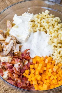 a bowl filled with macaroni and cheese, chicken, bacon, and sour cream