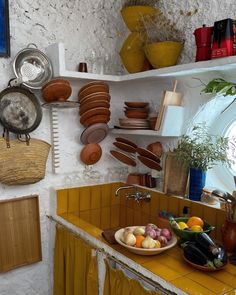 a kitchen filled with lots of different types of pots and pans on the wall